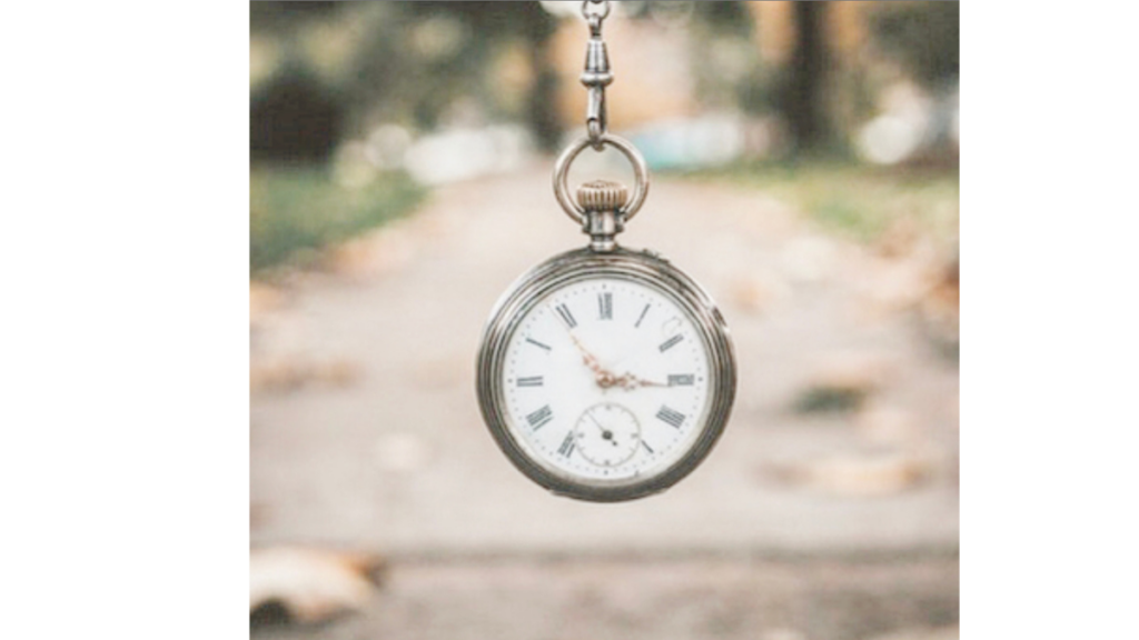 old fashioned stop watch with autumn leaves in the background