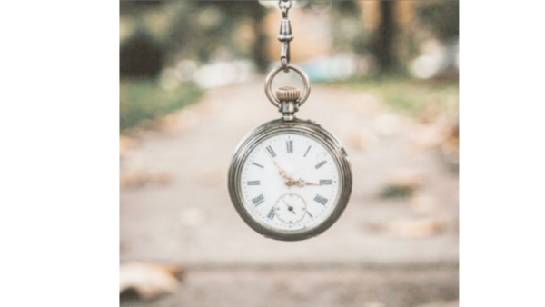 old fashioned stop watch with autumn leaves in the background