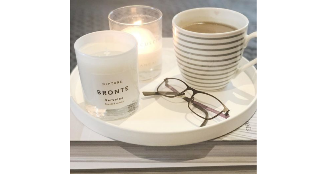 candles and a mug on a ceramic tray
