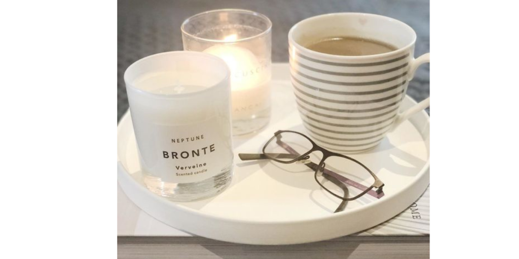 candles and a mug on a ceramic tray