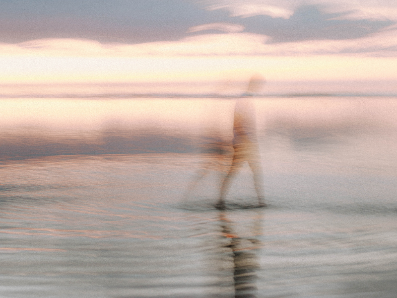 person walking on beach representing stress management