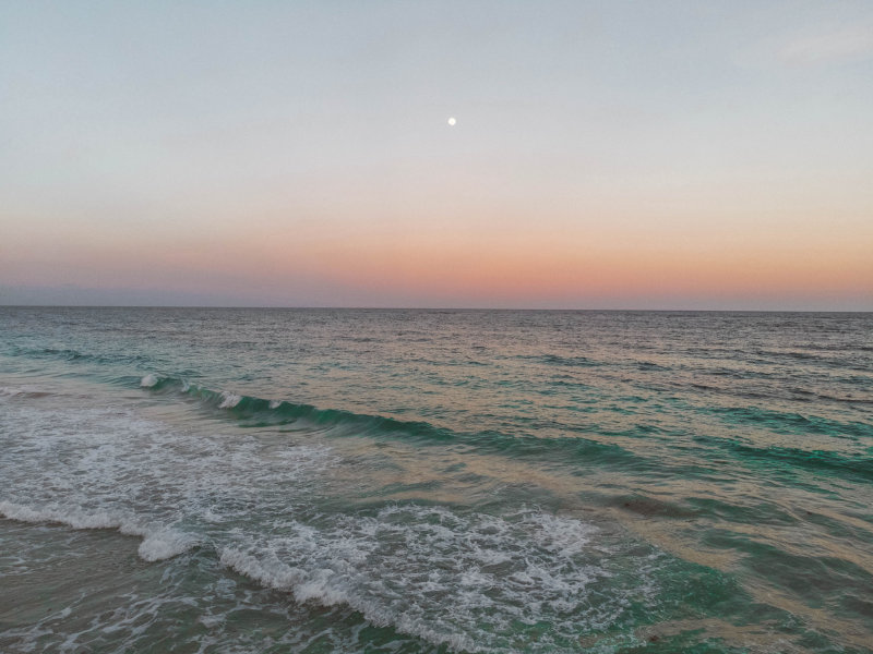 calm beach at sunset representing stress management