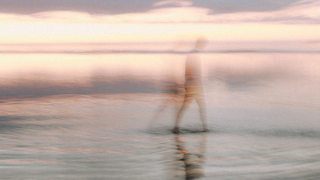 person walking on beach representing stress management
