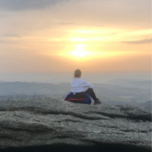 image of me sitting overlooking Dartmoor as the sun rises 