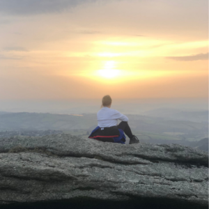 image of me sitting overlooking Dartmoor as the sun rises