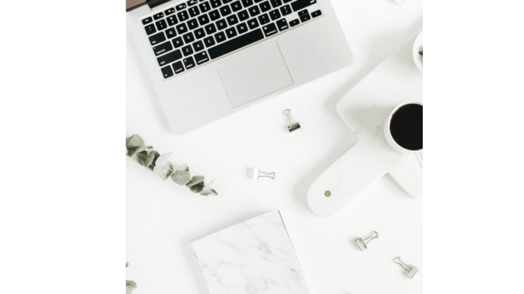 flatly view of a laptop, coffee and chocolate