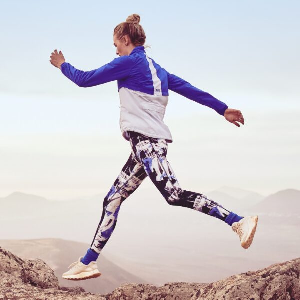 lady leaping wearing fitness clothes