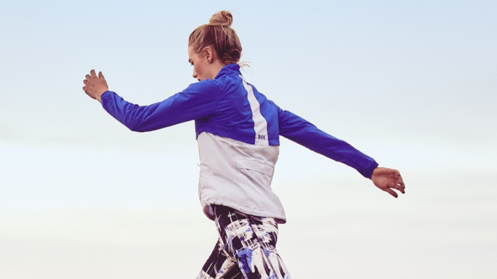 lady with blonde hair jumping in workout clothes