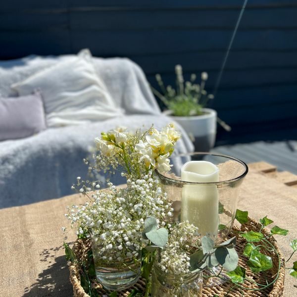 image of table and l shaped sofa from hay bales