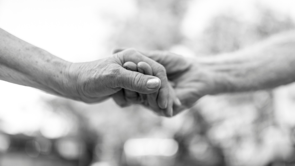 B&W image of couple holding hands 