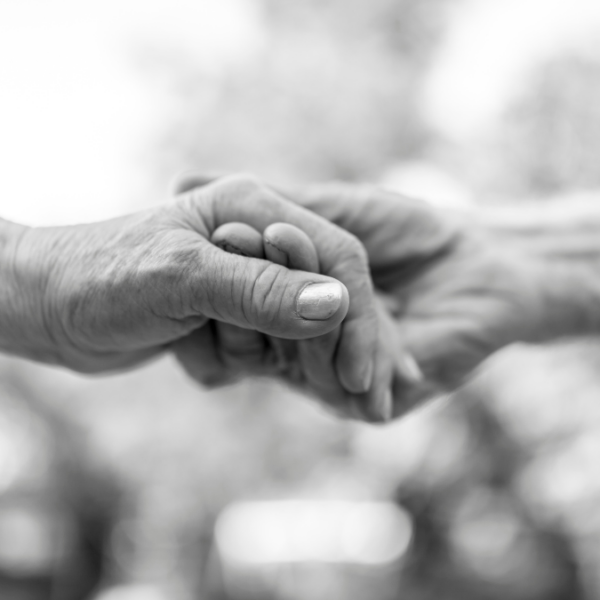 B&W image of couple holding hands