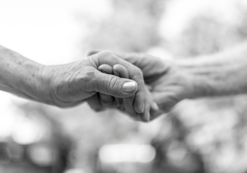 B&W image of couple holding hands