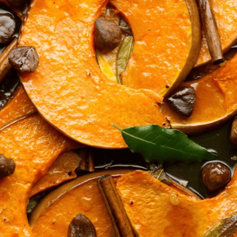 Pumpkin season : close up of roasted pumpkin with bay leaves cinnamon and chestnuts 